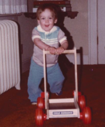 Son with wagon as "crutch" before he could walk
