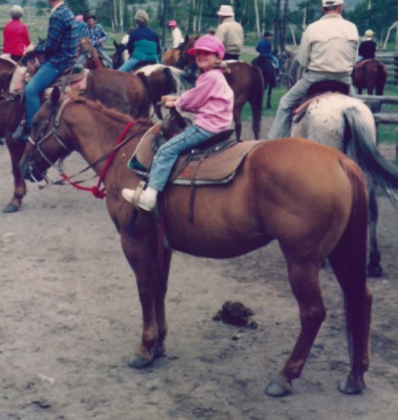 Daughter on Two Cents -- little girl on big horse, and proud of it