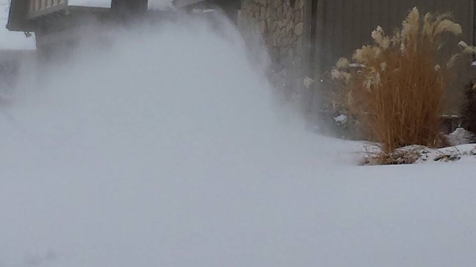 Husband running snowblower in frigid cold and wind