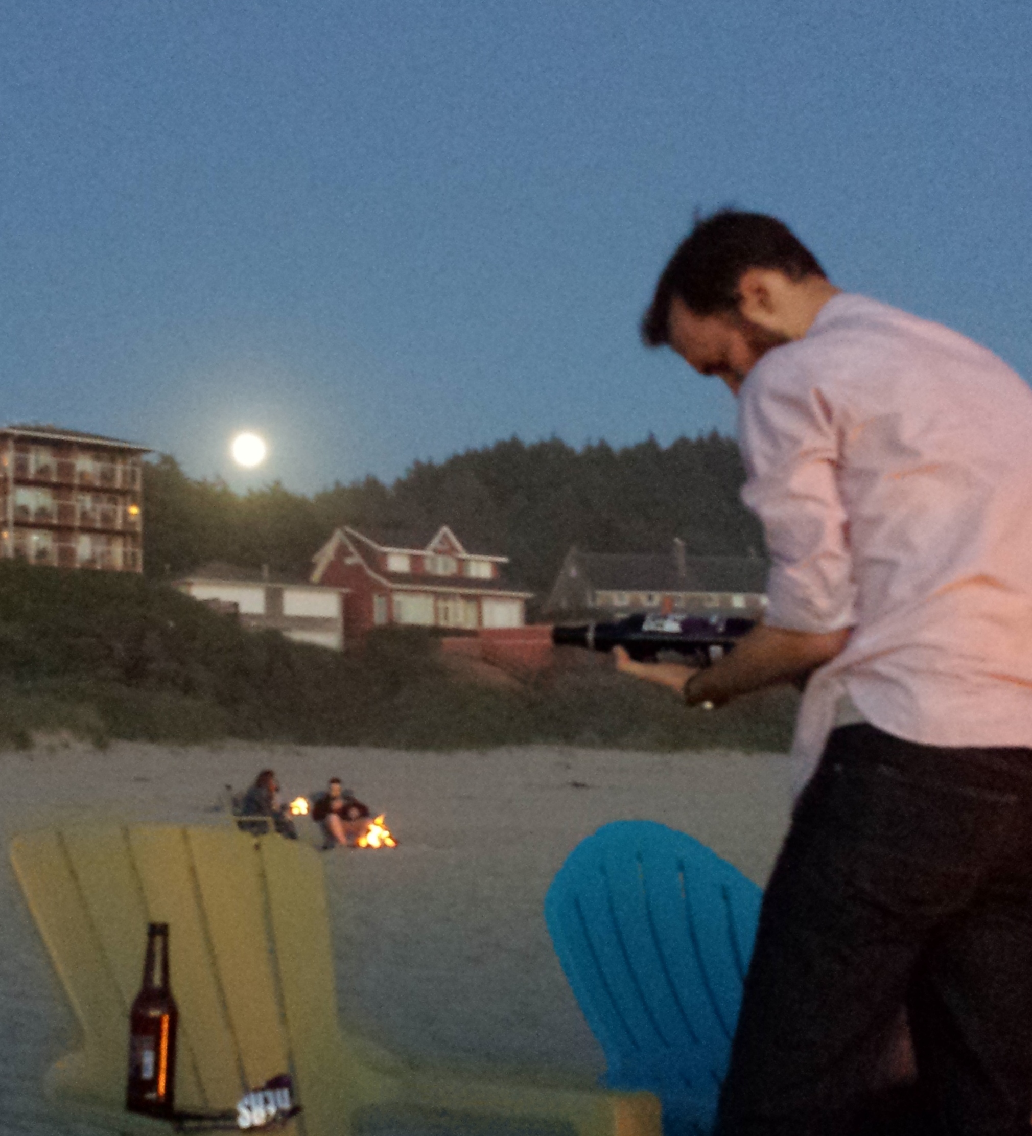 My son (with beer, not s'mores) on the beach, with the full moon rising